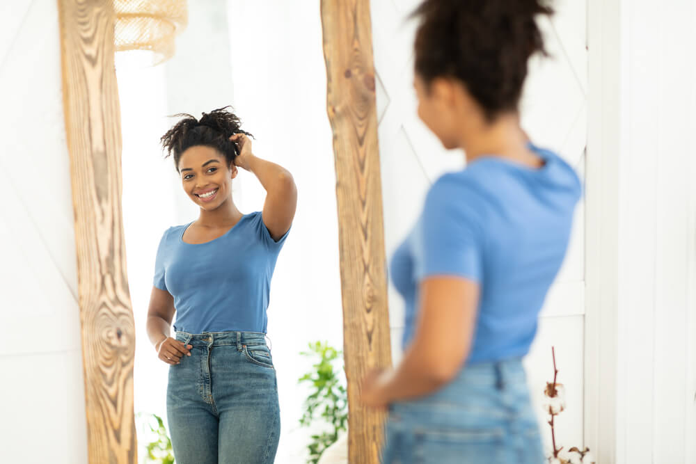 Cheerful Lady Posing Near Mirror After Slimming